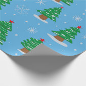 Grüne Weihnachtsbäume mit fallendem Schnee auf bla Geschenkpapier (Ecke)