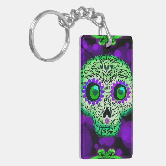 Grünes und Lila glühendes Zuckerschädel Halloween Schlüsselanhänger (Vorderseite links)