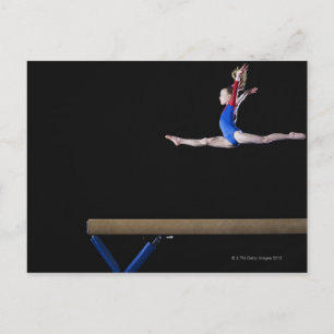 Gymnast (9-10) leaping on balance beam 2 postkarte