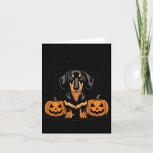 Halloween schwarzer und brauner Dachshund-Hund mit Karte