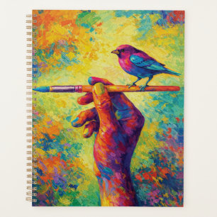 Hand mit Pinsel und kreativem Vogel Planer