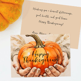 Hände sanft halten einen Pumpkin-Erntedank Feiertagskarte