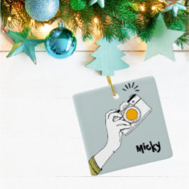 Handklick auf eine Kamera-Ornament im Cartoon Keramikornament