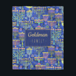 Hanukkah Blue Gold Menorah Star von David Name Fleecedecke<br><div class="desc">Diese individuelle Hanukkah Fleece-Decke ist mit einem schicken Muster aus Gold,  Grün und lila Menorah und Goldstar von David auf einem blauen Hintergrund mit Ihrem Familiennamen in Imitate Gold zu personalisieren. Dekorieren Sie Ihre Zuhause im Stil! Entworfen von weltberühmten Künstler ©Tim Coffey.</div>