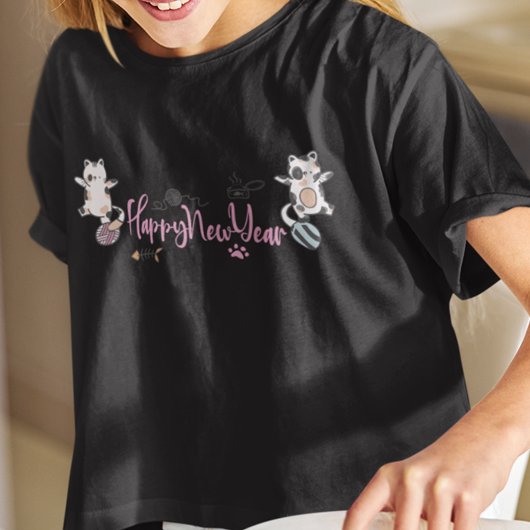 Happy New Year between Kittens Balanced on a Yarn T-Shirt