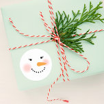Happy Winter Snow Lady Holiday Runder Aufkleber<br><div class="desc">Your friends and family will smile this winter season with these cute custom snowman stickers. Design features a jolly snow lady with warm rosy cheeks,  eyelashes,  a carrot nose and smile made of coal. Snow white,  black,  pink and orange design colors.</div>