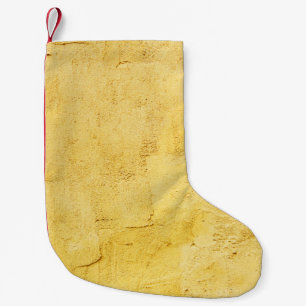 hellgelbes abstrakt strukturiertes Gips an der Wan Kleiner Weihnachtsstrumpf