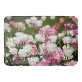Hellweiße und rosa Tulpen auf sonniger Höhe Badematte