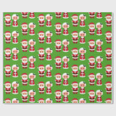 Herr und Frau Santa Clause über einen grünen Hinte Geschenkpapier (Flach)