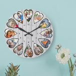 Herzgeformte Fotos Leichtes graues Holz Große Uhr<br><div class="desc">Erstellen Sie Ihre eigene Multi-Foto-Uhr. Die Bildvorlage ist für Sie ein Set, um 12 Fotos hinzuzufügen, die in einem herzförmigen Rahmen angezeigt werden. Das Design verwendet porträtierte vertikale Fotos für alle Zahlen außer 3 und 9, die im Querformat horizontal angeordnet sind. Das Uhrengesicht hat einfache Zahlen mit einem modernen hellgrauen...</div>