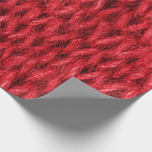 Hintergrund aus roter Strickwolle. Geschenkpapier (Ecke)