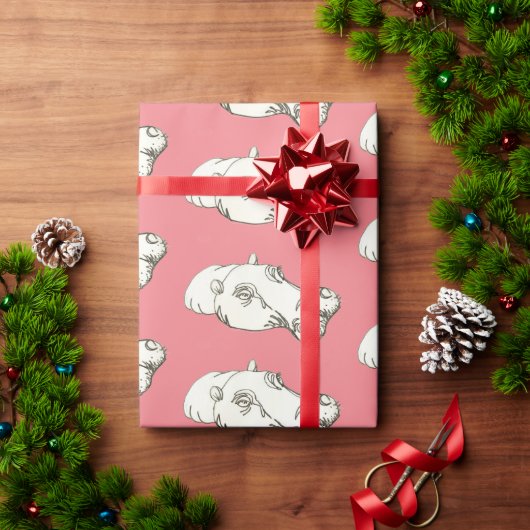Hippo zeichnend auf rosa geschenkpapier (Feiertagsgeschenk)