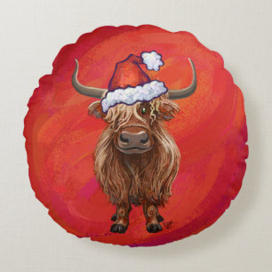 Hochlandkuh in Weihnachtsmannmütze auf Rot Rundes Kissen