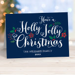 Holly Jolly Christmas Navy Blue Photo Feiertagskarte<br><div class="desc">"Have a Holly Jolly Christmas" holiday greeting cards feature a dark navy blue background,  white handwritten style script,  and festive berries,  holly leaves,  poinsettia,  and winter evergreen design accents. Personalize with a photo and custom message on the inside.</div>