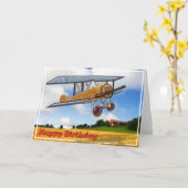 Hölzerner Doppeldecker über Feld-alles Gute zum Karte (Gelbe Blume)