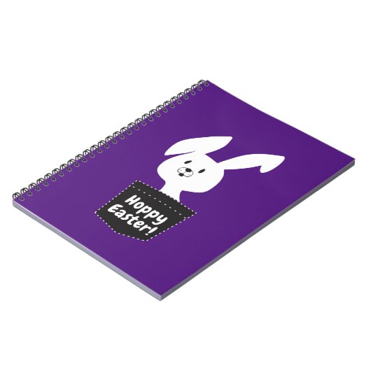 Hoppy Osterwünschung mit weißem Hasen auf Lila Notizblock (Linke Seite)