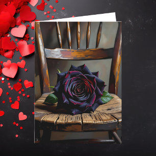 Hübsche schwarze Rose auf rustikalem Stuhl Valenti Karte