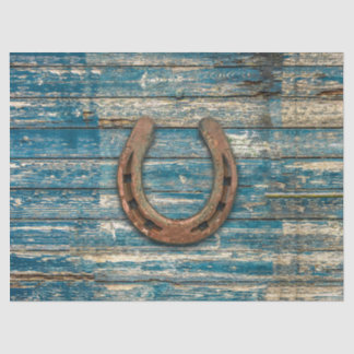 Hufeisen auf blauen hölzernen Brettern Seidenpapier