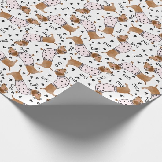 Hunde mit niedlicher Dackel, die rosa Pullover tra Geschenkpapier (Ecke)