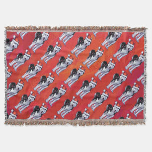 Husky in Weihnachtsmannmütze auf Rot Decke