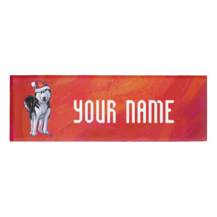 Husky in Weihnachtsmannmütze auf Rot Namenschild