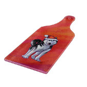 Husky in Weihnachtsmannmütze auf Rot Schneidebrett (Ecke)