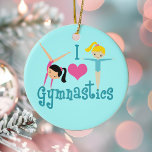 I Liebe Gymnastik Keramik Ornament<br><div class="desc">Ich Liebe Gymnastik. Ein hübsches Gymnastikgeschenk mit bezauberndem aquamarinem Text zwischen zwei niedlichen,  schwindelnden kleinen Mädchen und einem schönen rosa Herz. Ein niedliches Gymnastikgeschenk für Kinder oder Damen. Ein brünett in einer Handablage und ein blondes Mädchen mit ausgestreckten Armen.</div>