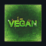 Ich bin Vegan mit einer grasbewachsenen Naturstruk Magnet<br><div class="desc">Ich bin vegan in hellgrün auf einer dunkelgrünen Leinwand wie Hintergrund geschrieben. Das Wort vegan ist mit einer grünen grasähnlichen Textur geschrieben. Kleine naturbezogene Ladybugs,  Gänseblümchen und Blätter schmücken die Worte.</div>