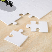 Illustration eines Lambeosaurus, der ein Ei hält. Puzzle (Seite)