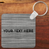 Imitate Schlüsselanhänger mit grauem Stoff mit ben (Rückseite)