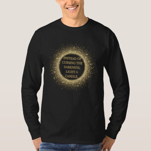 Instead of cursing the darkness, light a candle. T-Shirt (Vorderseite)