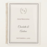 Ivory taupe monogrammed wedding planer<br><div class="desc">Streamline your schedule with this sophisticated wedding planner. It features a taupe laurel wreath monogram crest and a clean double-border frame on a warm ivory background. This 12-month diary is a thoughtful engagement gift for the bride who loves timeless,  traditional style.</div>