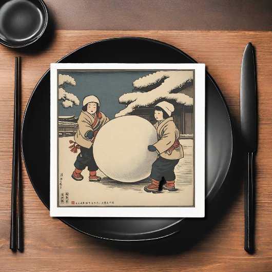 Japanese children rolling large snow ball serviette