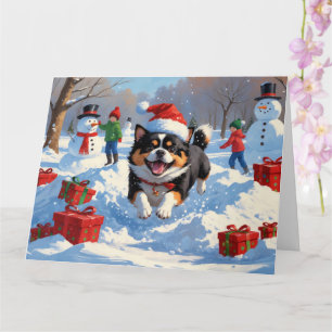 Japanisches Kinn im Schnee mit Weihnachtsmütze Karte