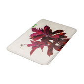 Jatropha-Pflanze in tiefrotem Badematte (Schrägansicht)