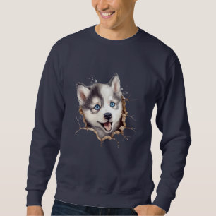 Jenseits der Barriere: Ein Husky-Welpe spielt Sweatshirt
