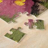 Junge mit Strohhut spielt mit Entlein Puzzle (Seite)