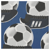 Jungenfußballfußbalstiefel und -ball stoff (Nahaufnahme)