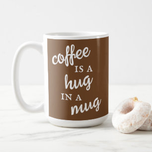 Kaffee ist ein Umarmer in einer Tasse, braun und w Kaffeetasse