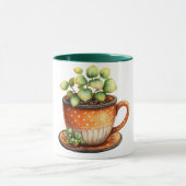 Kaffeetasse mit Kaffeetasse mit Pflanze darin (Zentrum)
