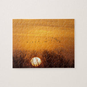 Kanadakraniche gegen aufgehende Sonne silhouettier Puzzle