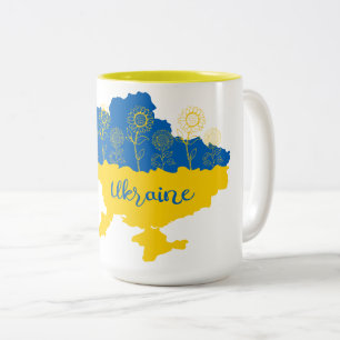 Karte der Ukraine mit Sonnenblumen und ukrainische Zweifarbige Tasse
