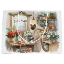 Katze arrangiert Winterblumen für Weihnachten