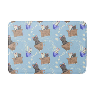 Katzen in Kiste und Milchfallen auf blau Badematte