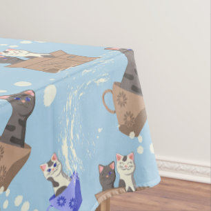 Katzen in Kiste und Milchfallen auf blau Tischdecke