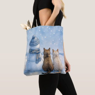 Katzensitzend mit einem Schneemann auf einem Feld Tasche