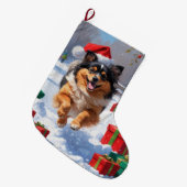 Keeshond Hund läuft im Schnee mit Weihnachtshut Großer Weihnachtsstrumpf (Vorderansicht (hängend))