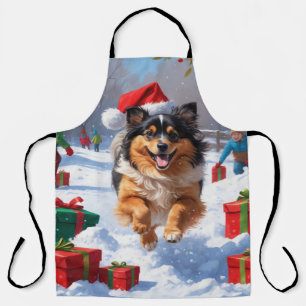 Keeshond-Hund läuft im Schnee mit Weihnachtsmütze Schürze