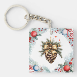 Kiefernkone, umgeben von Kränzen und Ornamenten Schlüsselanhänger