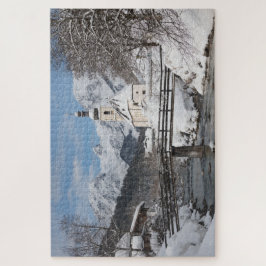 Kirche im Schnee mit den Alpen im Winter Puzzle